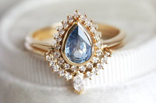 Elegant teardrop-shaped engagement ring with a sparkling diamond center set in a delicate band, symbolizing love and timeless beauty.
