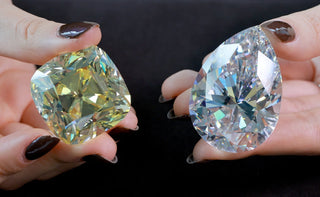 A natural diamond being inspected under magnification at an auction house for valuation based on cut, clarity, and carat.