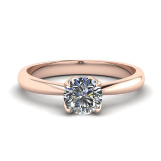 Diamond ring set in rose gold, highlighting the warm hue of the metal as a stylish alternative to traditional settings.