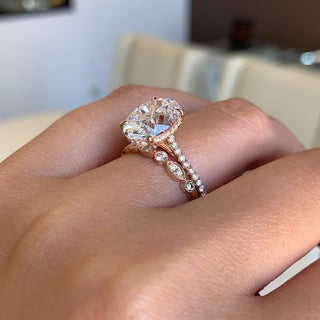 Close-up of rose gold rings and bracelets arranged on a soft blush fabric, highlighting their warm tones and elegant craftsmanship.
