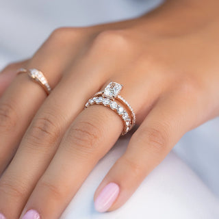 A side-by-side comparison of a pre-set engagement ring and a custom-designed ring sketch with loose stones—illustrating the choice between ready-made convenience and personalized design.