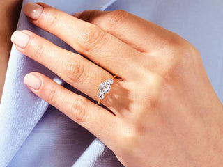 Side-by-side view of a classic solitaire ring and an elegant three-stone ring, highlighting their distinct styles and diamond settings.