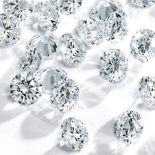 Loose diamonds placed on a valuation chart highlighting depreciation in resale value.