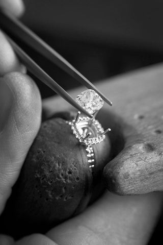 A lab diamond ring sparkling on a recycled jewelry box, symbolizing sustainable luxury and ethical elegance.