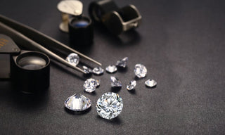 A jeweler examining a diamond through a loupe, comparing lab-grown and natural stones under bright lighting on a gem tray. 