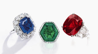 Diamond, ruby, sapphire, and emerald gemstones displayed side by side, representing the four main precious stones in fine jewelry.