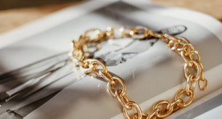 A worn gold-plated bracelet showing faded areas and exposed base metal—highlighting common issues like tarnishing and durability that make gold-plated jewelry a less ideal choice for long-term wear.