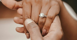 A single diamond ring placed on a closed jewelry box, symbolizing post-breakup decisions about diamond jewelry.