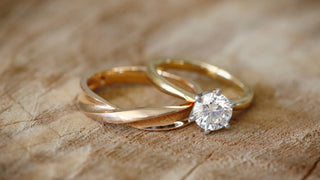 A close-up of a gold ring showing the 750 stamp, highlighting the mark of 18K gold purity.