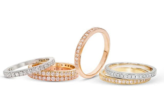A close-up of hypoallergenic jewelry pieces, including titanium and platinum earrings and necklaces, displayed on soft fabric—ideal for people with sensitive skin due to their gentle, non-irritating materials.