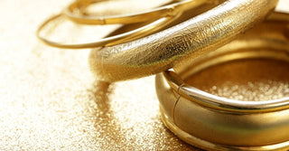 A gold-filled bracelet beside a cutaway diagram showing its layered structure, explaining the value and composition of gold-filled jewelry.