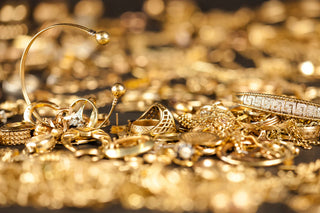 A timeline-inspired display of gold jewelry pieces from ancient Egyptian, Roman, and modern eras—showcasing gold’s enduring appeal and its evolution in design through centuries of jewelry history.