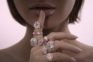 Luxury pink diamond rings with halo settings and designer fashion jewelry styled on fingers for an elegant women’s jewelry photoshoot