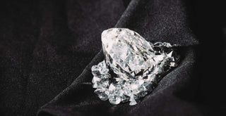 A close-up of a diamond under magnification, showing the distinctive marks of laser drilling.