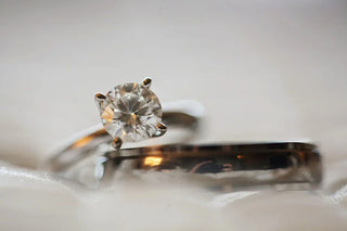 Elegant 4 claw diamond engagement ring displayed on a velvet box, showcasing a secure and stylish setting ideal for highlighting a brilliant diamond.