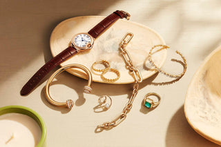 A luxury diamond necklace placed beside financial documents and a calculator, questioning the value of jewelry as an investment.
