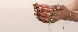 Sterling silver ring with water droplets on a smooth surface, symbolizing exposure to moisture and jewelry care concerns.