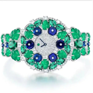 Blueberry Aurora Watch for women with a silver case, sapphire crystal dial, and glimmering green and blue stone accents.