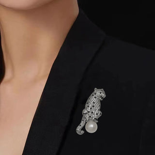 Copper and silver Panther On The Pearl Brooch with lab-created sapphires draped on a luminous pearl, measuring 