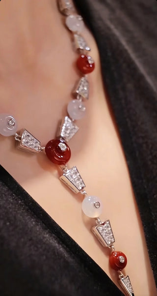Crimson Bind Necklace for women, made from 925 sterling silver with platinum plating and a red lab-created sapphire. Elegant Y-shaped design with a modern twist.
