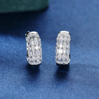 Duchess of Ice Earrings – Sterling silver earrings with white lab-created sapphires, offering a crisp, refined sparkle inspired by winter’s elegance.