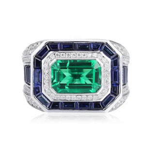 Azzallure Emerald Tempest Ring featuring a 3.18-carat emerald green lab sapphire, surrounded by blue and silver lab stones in a sterling silver diamond-style setting.

