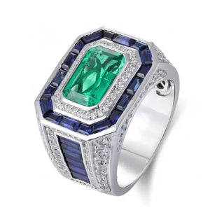 Azzallure Emerald Tempest Ring featuring a 3.18-carat emerald green lab sapphire, surrounded by blue and silver lab stones in a sterling silver diamond-style setting.


