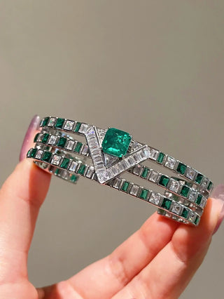 Emerald Vine Bracelet in sterling silver, featuring a vivid lab-created emerald sapphire surrounded by delicate side stones, evoking natural elegance.