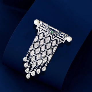 Freshwater pearl brooch pin set in polished copper and silver, accented with lab-created sapphires.