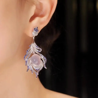 Glacial Grace Earrings: 54.6 mm drop earrings in 925 sterling silver plated with 18K white gold, set with lab-created sapphire stones.