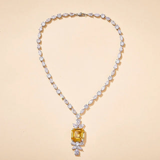 Gold-fused sterling alloy necklace featuring a central yellow lab-created sapphire framed by white sapphires, evoking regal vintage elegance.