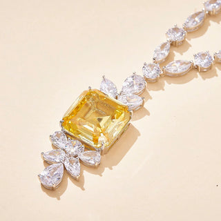 Gold-fused sterling alloy necklace featuring a central yellow lab-created sapphire framed by white sapphires, evoking regal vintage elegance.