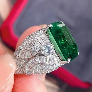 Elegant sterling silver ring with a vivid green emerald-cut lab-created Colombian stone, exuding royal charm and timeless elegance, inspired by heritage and natural beauty.

