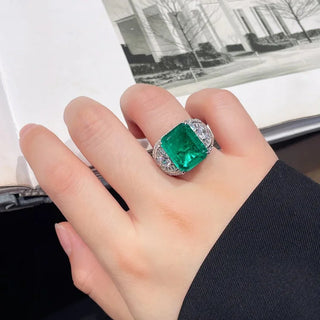 Elegant sterling silver ring with a vivid green emerald-cut lab-created Colombian stone, exuding royal charm and timeless elegance, inspired by heritage and natural beauty.


