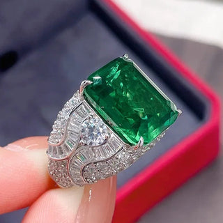Elegant sterling silver ring with a vivid green emerald-cut lab-created Colombian stone, exuding royal charm and timeless elegance, inspired by heritage and natural beauty.

