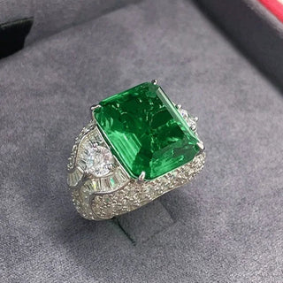 Elegant sterling silver ring with a vivid green emerald-cut lab-created Colombian stone, exuding royal charm and timeless elegance, inspired by heritage and natural beauty.

