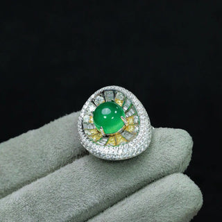 Sterling silver sunburst ring featuring a central jade stone with radiating yellow and white lab sapphires in a vibrant, green statement design.