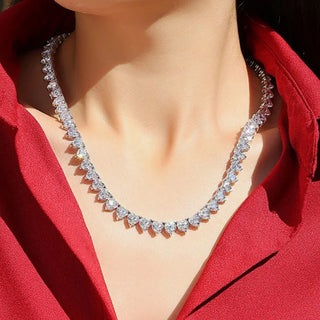 Close-up of Azzallure's Heart Tennis Necklace featuring heart-shaped Moissanite stones set in a silver tennis chain—elegant, minimal, and radiant.

