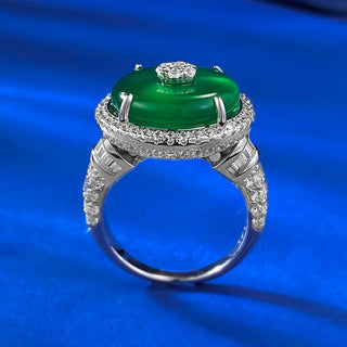 Jade Dynasty Ring featuring a natural green jade stone set in solid 925 sterling silver, framed by lab-created sapphires, symbolizing elegance and cultural significance. A timeless, versatile piece suitable as a wedding band or heirloom, combining tradition with contemporary design.