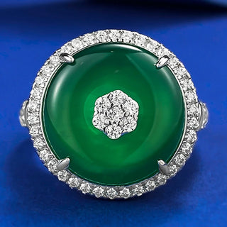 Jade Dynasty Ring featuring a natural green jade stone set in solid 925 sterling silver, framed by lab-created sapphires, symbolizing elegance and cultural significance. A timeless, versatile piece suitable as a wedding band or heirloom, combining tradition with contemporary design.