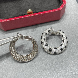 Leopard Spots Earrings – Sterling silver earrings with a spotted pattern, adorned with lab-created sapphires, blending boldness and sophistication.