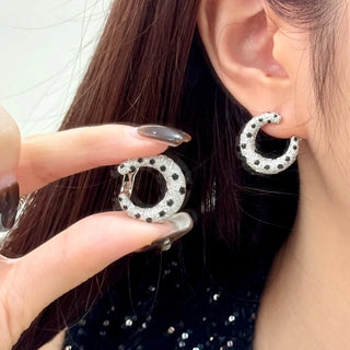 Leopard Spots Earrings – Sterling silver earrings with a spotted pattern, adorned with lab-created sapphires, blending boldness and sophistication.