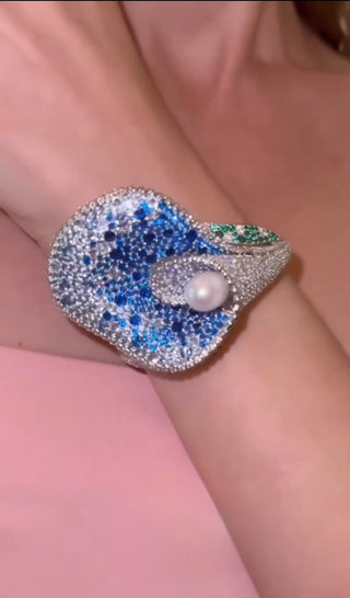 Lily’s Embrace Bracelet in 925 sterling silver featuring sculpted tulip petals, lab-created sapphires, and a central freshwater pearl