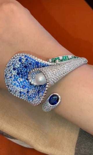 Lily’s Embrace Bracelet in 925 sterling silver featuring sculpted tulip petals, lab-created sapphires, and a central freshwater pearl