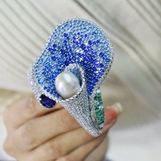 Lily’s Embrace Bracelet in 925 sterling silver featuring sculpted tulip petals, lab-created sapphires, and a central freshwater pearl