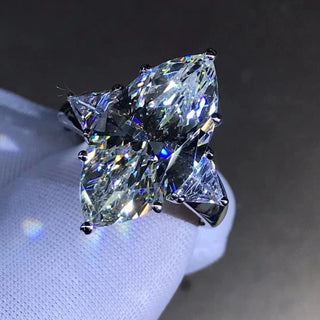 Maison Marquise engagement ring with 8-carat marquise Moissanite, diamond-style band in 925 silver, shown on hand

