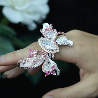 Papillon Pink Ring featuring a delicate butterfly-inspired design with shimmering pink gemstones, showcasing fine craftsmanship and elegant detail.

