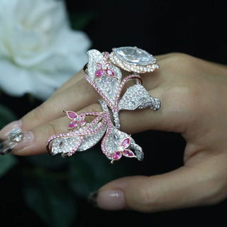 Papillon Pink Ring featuring a delicate butterfly-inspired design with shimmering pink gemstones, showcasing fine craftsmanship and elegant detail.

