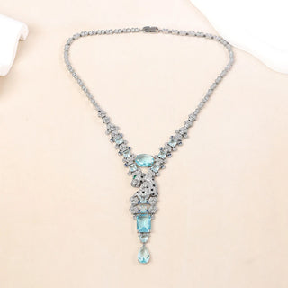 Sterling silver Paraiba Leopard Necklace with vivid sea-blue lab sapphire, pearl-inspired side stones, and a sleek feline design on an O chain.

