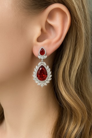 Rouge Teardrop Earrings: 925 sterling silver teardrop earring studs set with lab-created ruby sapphires, weighing 31 grams.